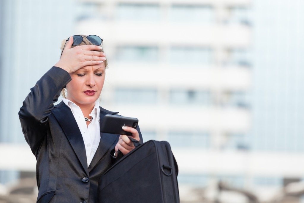 a worried businesswoman using her phone