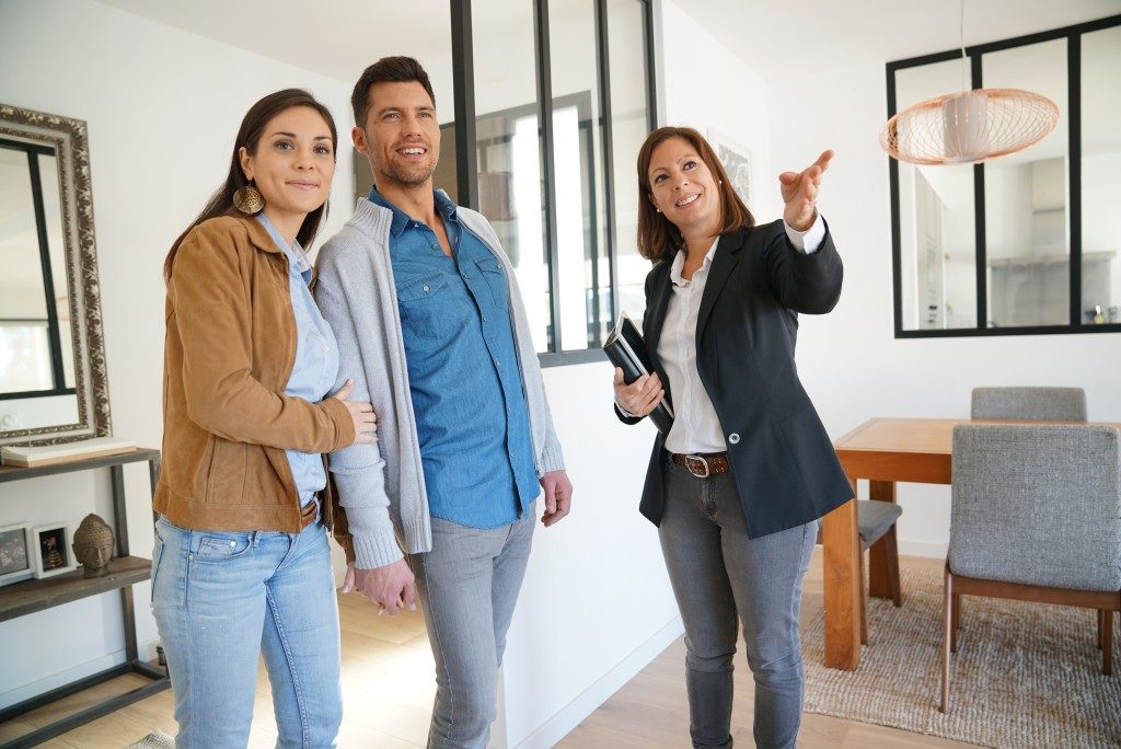 couple doing a house inspection with real estate agent