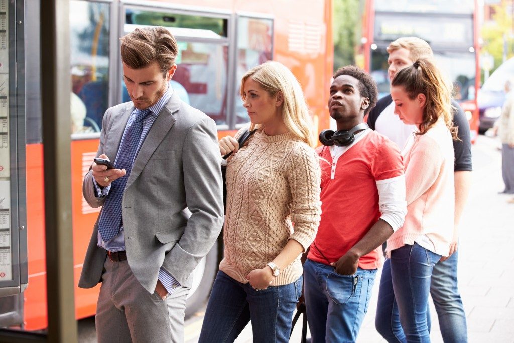 people waiting at bus stops