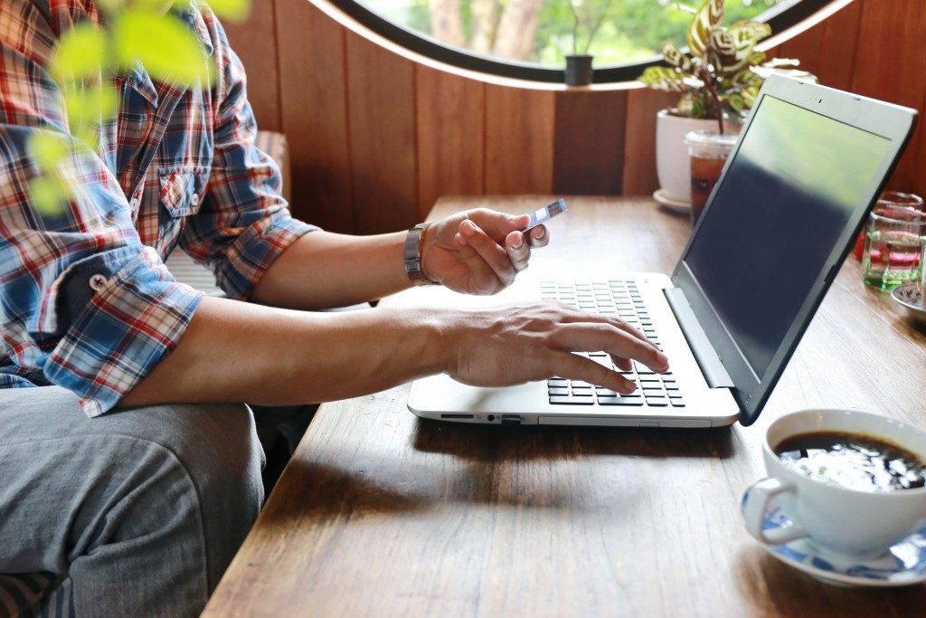 man shopping online on his laptop