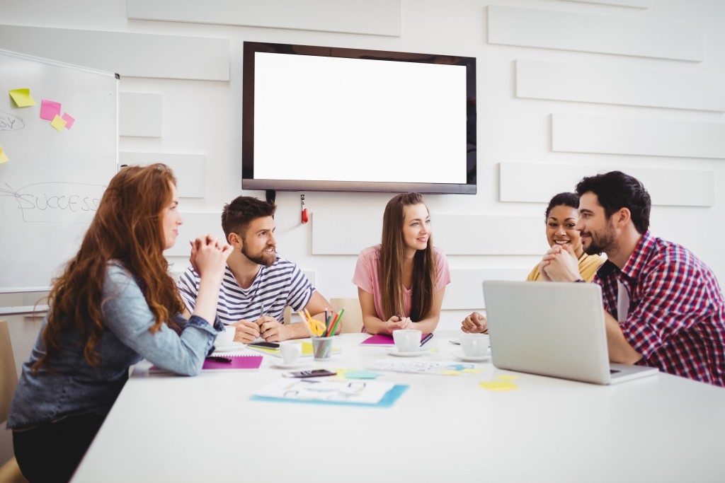 young coworkers discussing during meeting