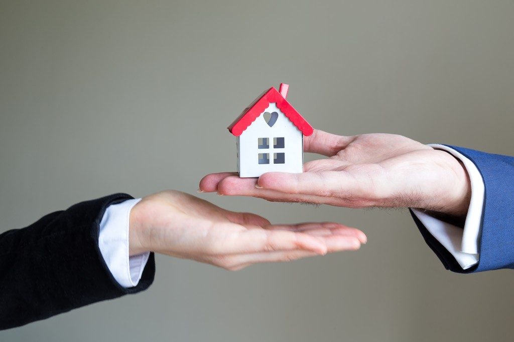 Handing house model real estate concept