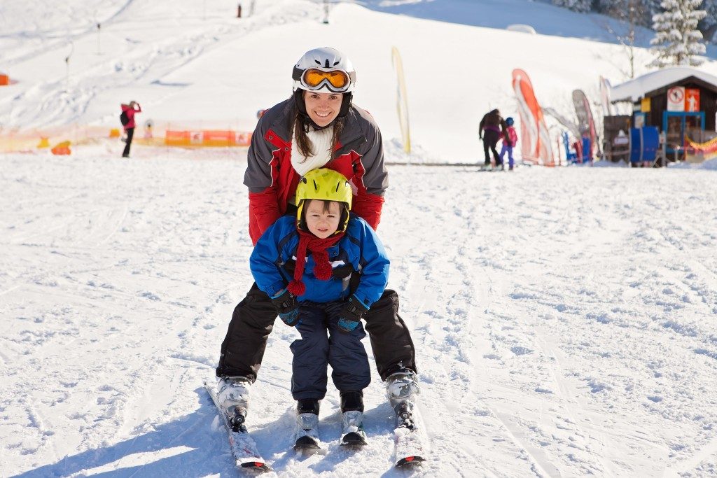 Mother teaching her son to ski