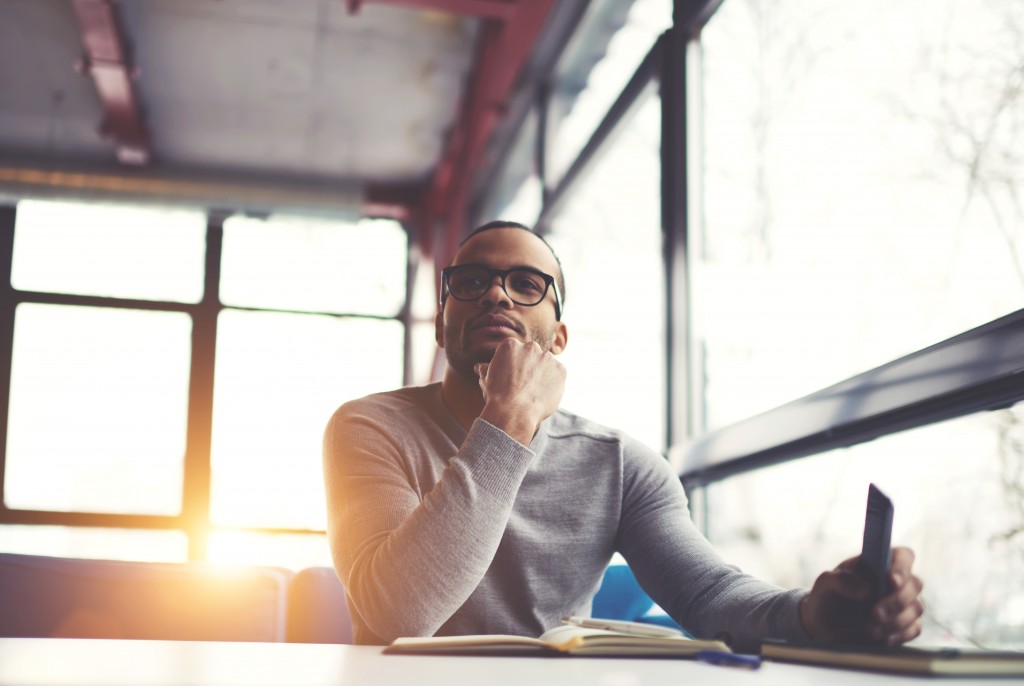 Man with glasses thinking