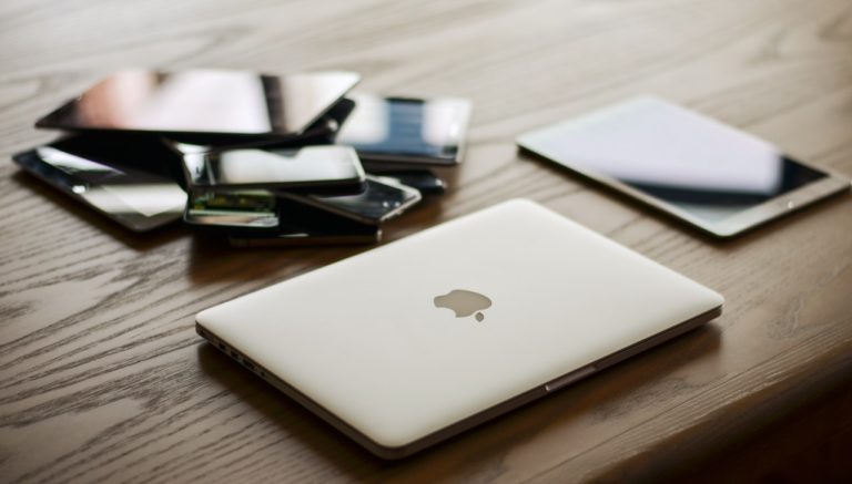 a laptop near a pile of phone