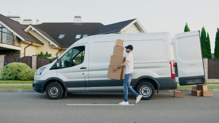 delivery man holding some boxes