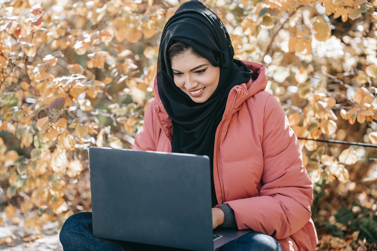 woman using her laptop outdoors