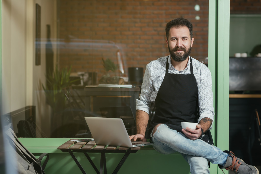 Barista typing on laptop