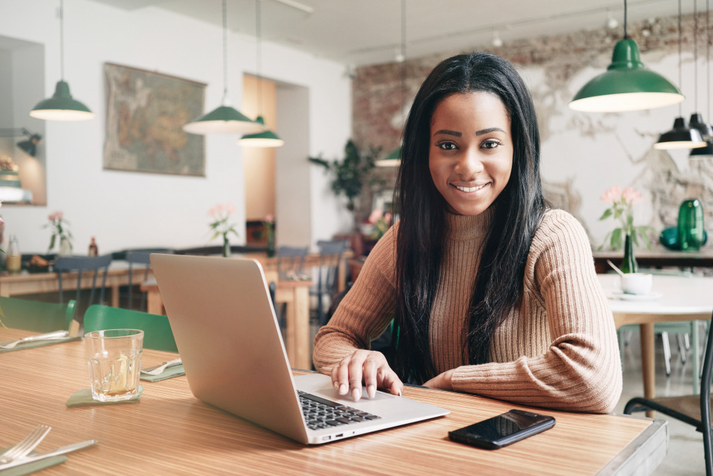 entrepreneur handling her business using a laptop