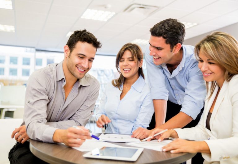 group of people looking at a paper