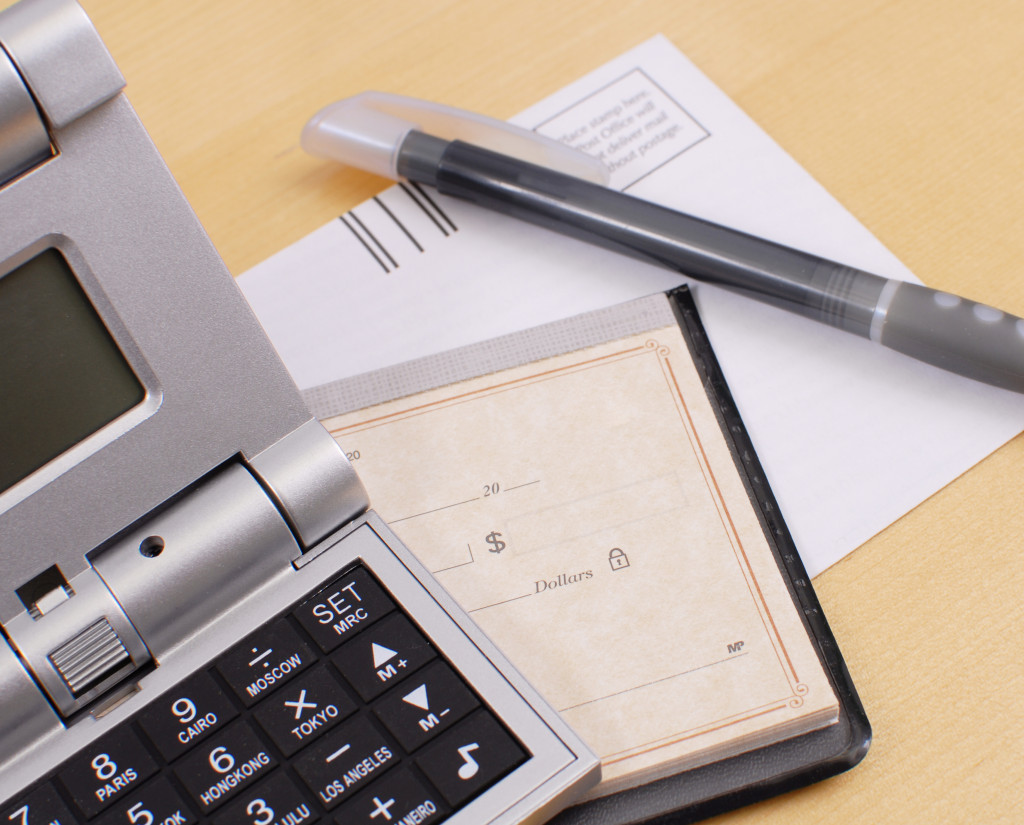 a calculator, passbook and paper