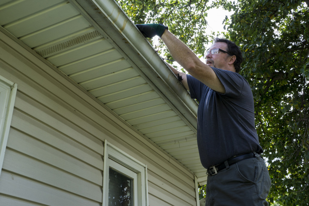 Cleaning gutters on a residential home.