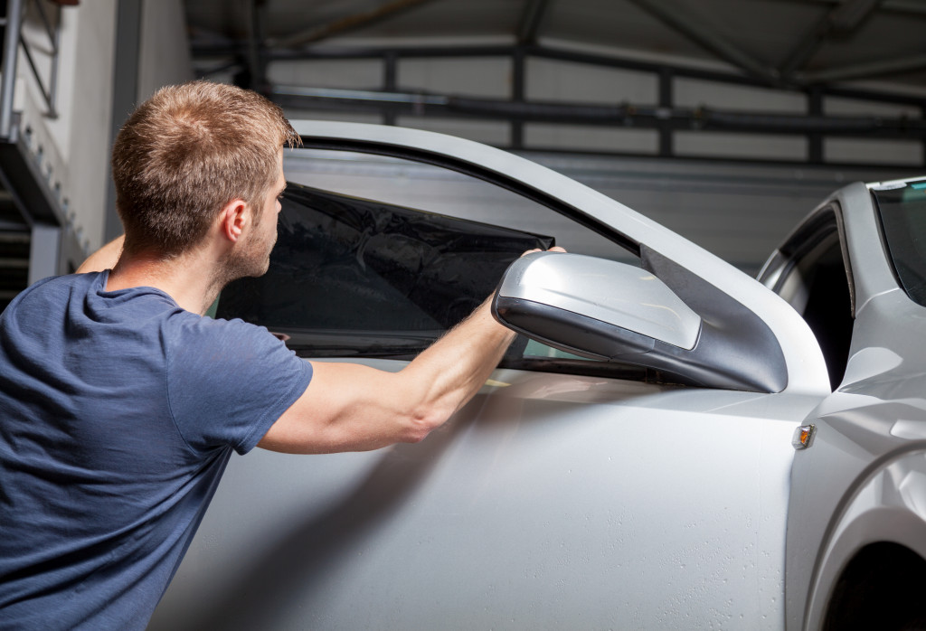 a person inspecting a car