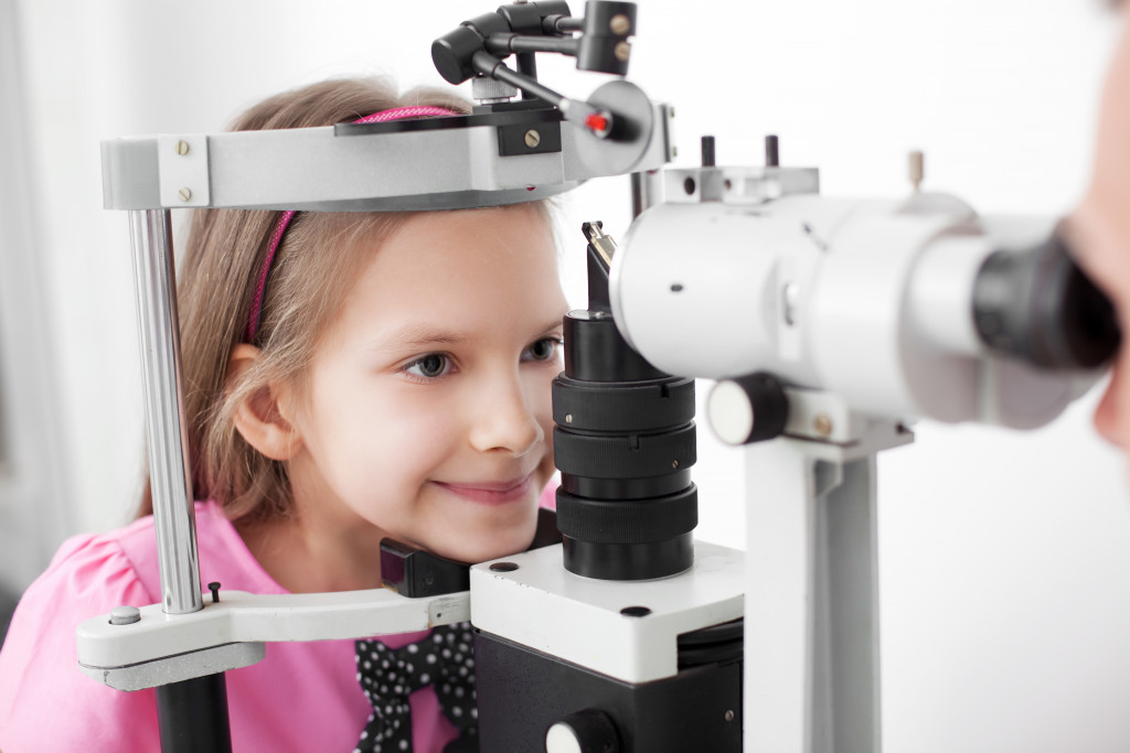 Optometrist performing visual field test of a young girl