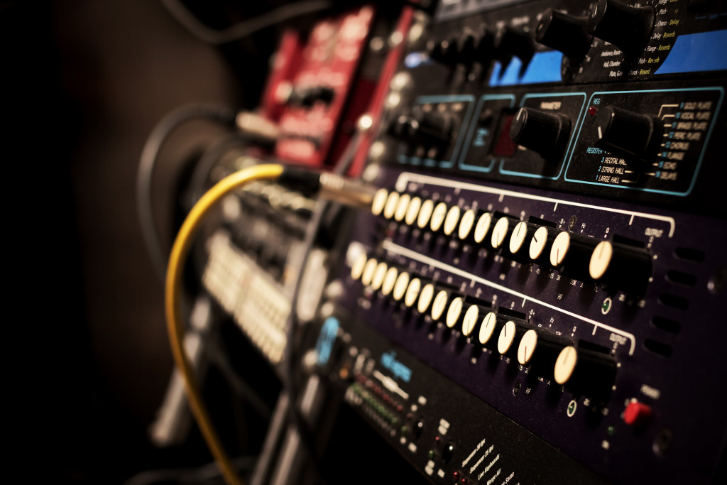 Recording studio gears in racks with a cord plugged in