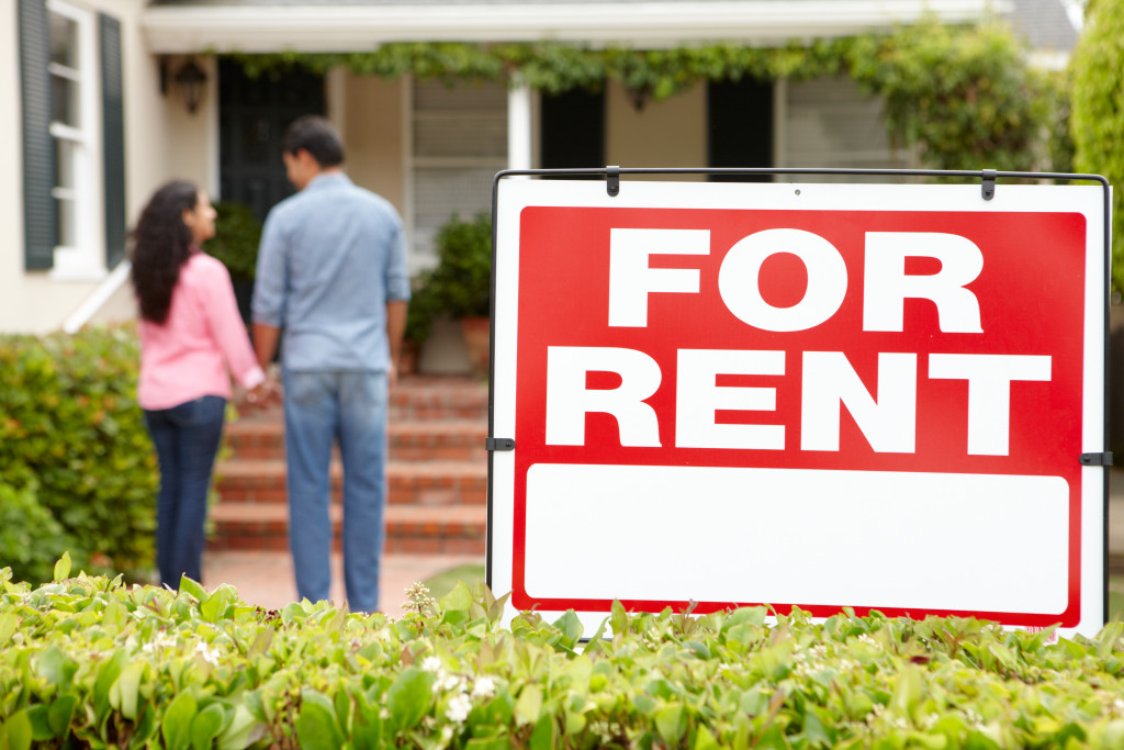 Couple standing outside a house for rent.