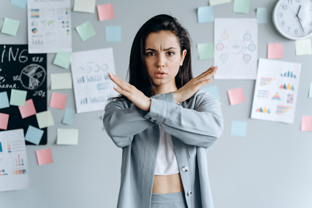 A woman saying no and using hands to show that