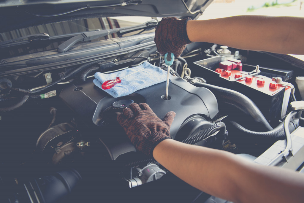 Electric car hood being checked by a mechanic in garage