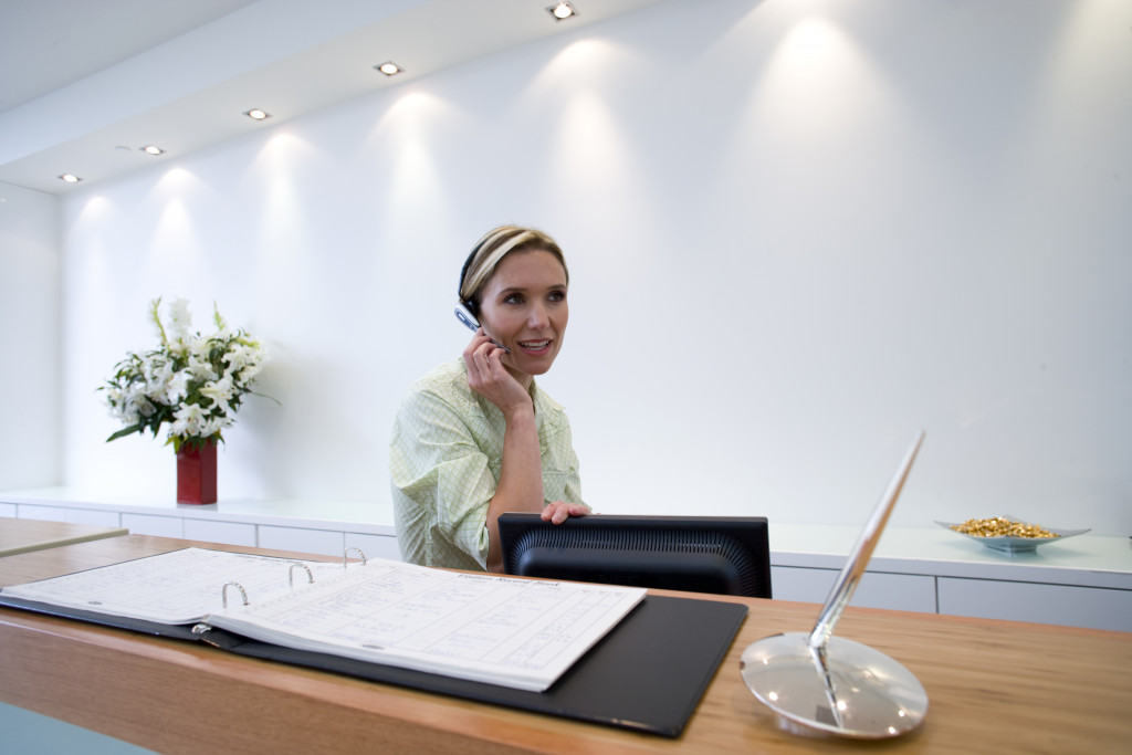 Receptionist behind desk with headset