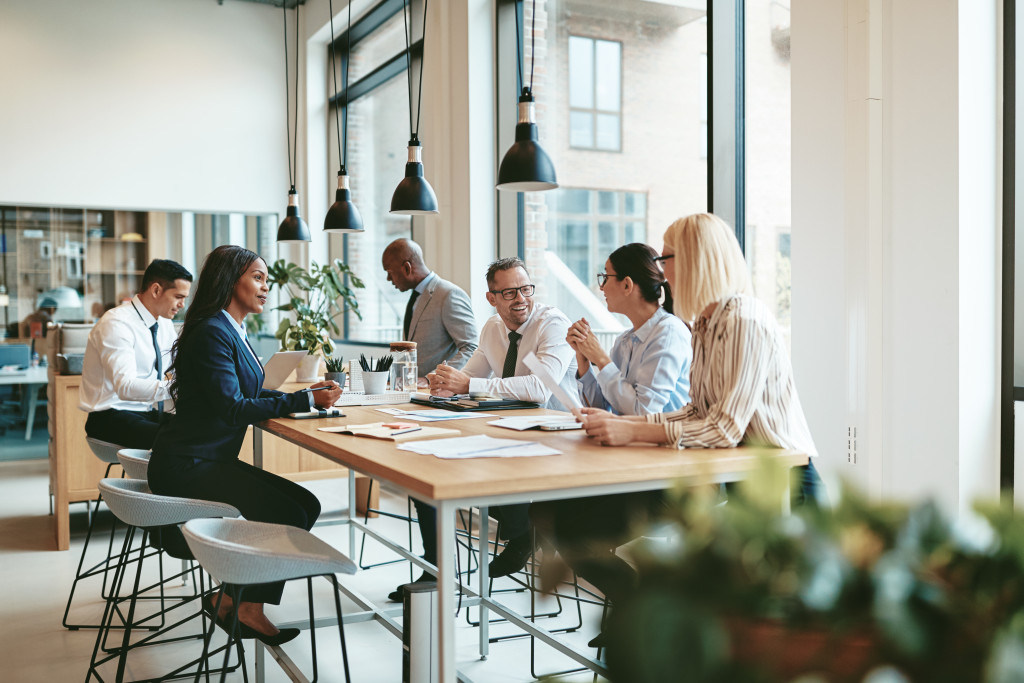 employees in a small office space having a meeting