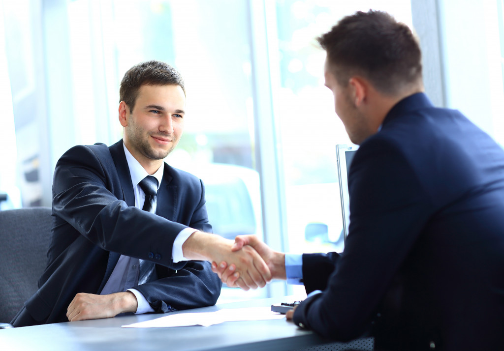 man meeting his client handshake