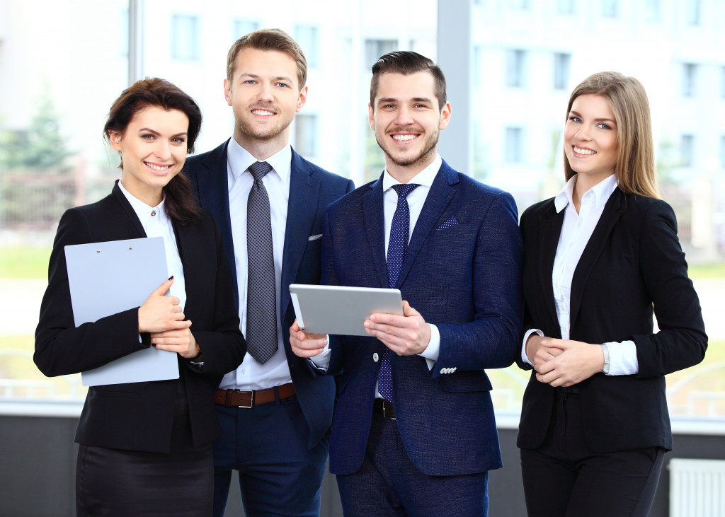 happy and satisfied employees smiling at camera