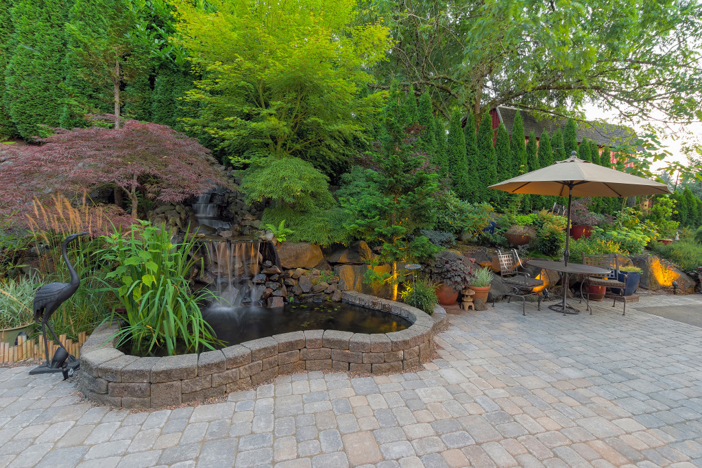 landscaping of garden with hardscape elements and water fountain