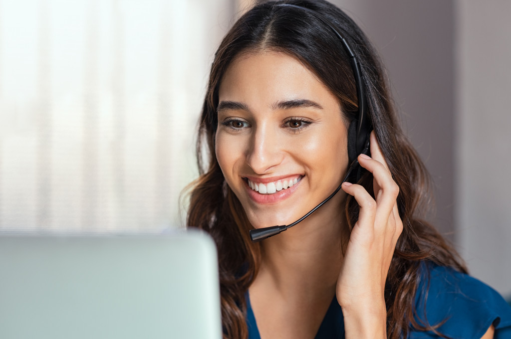 a woman using a headset to talk to customer