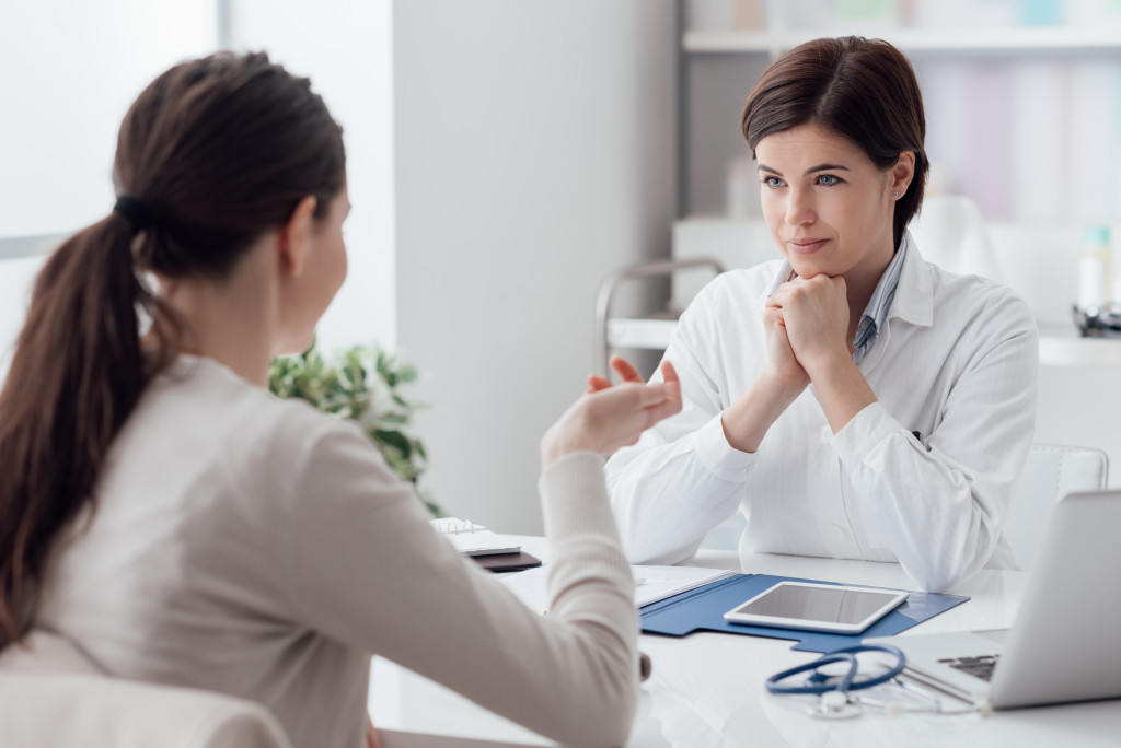 A woman talking to a doctor in a clinic