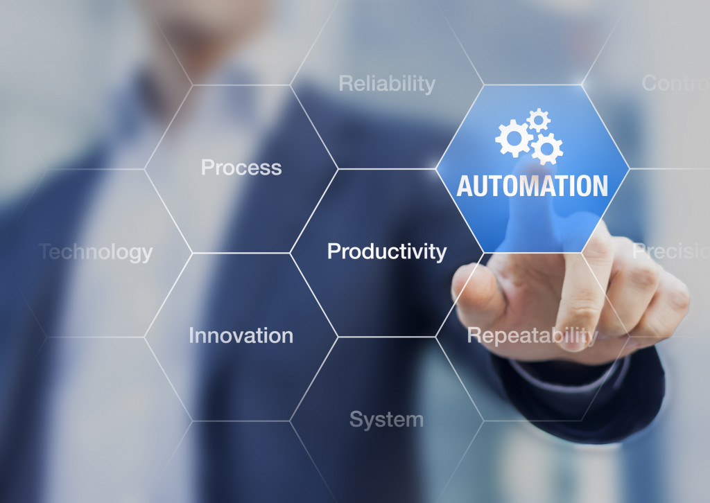 businessman touching automation icon to represent streamlining