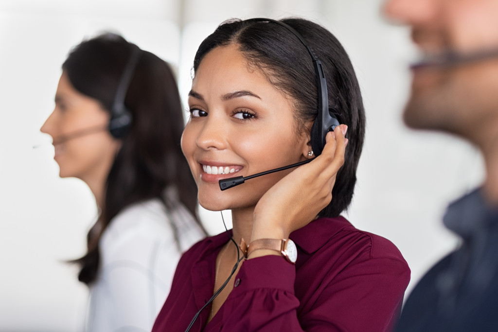 a woman on a headphone talking to a customer