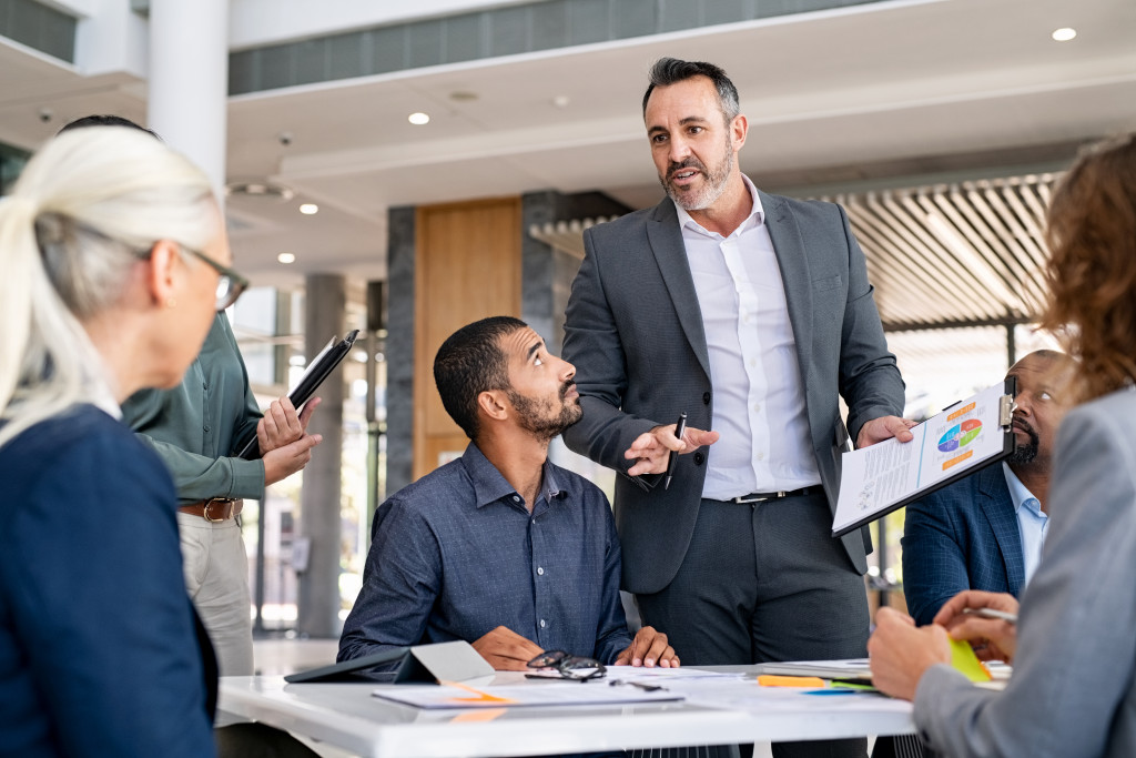 Business owner leading his team at an office.