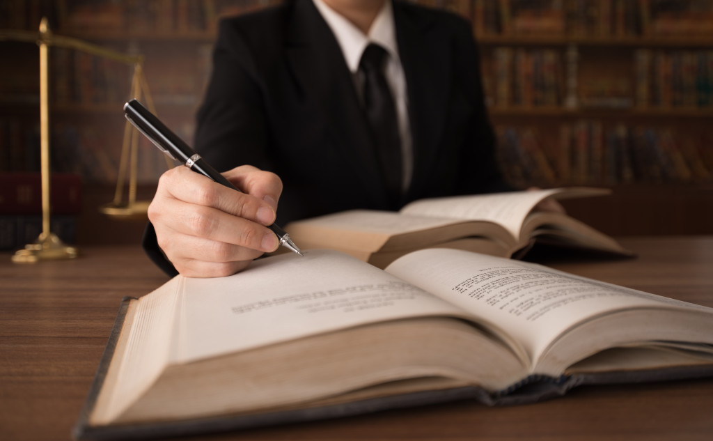 a lawyer with an open book while writing