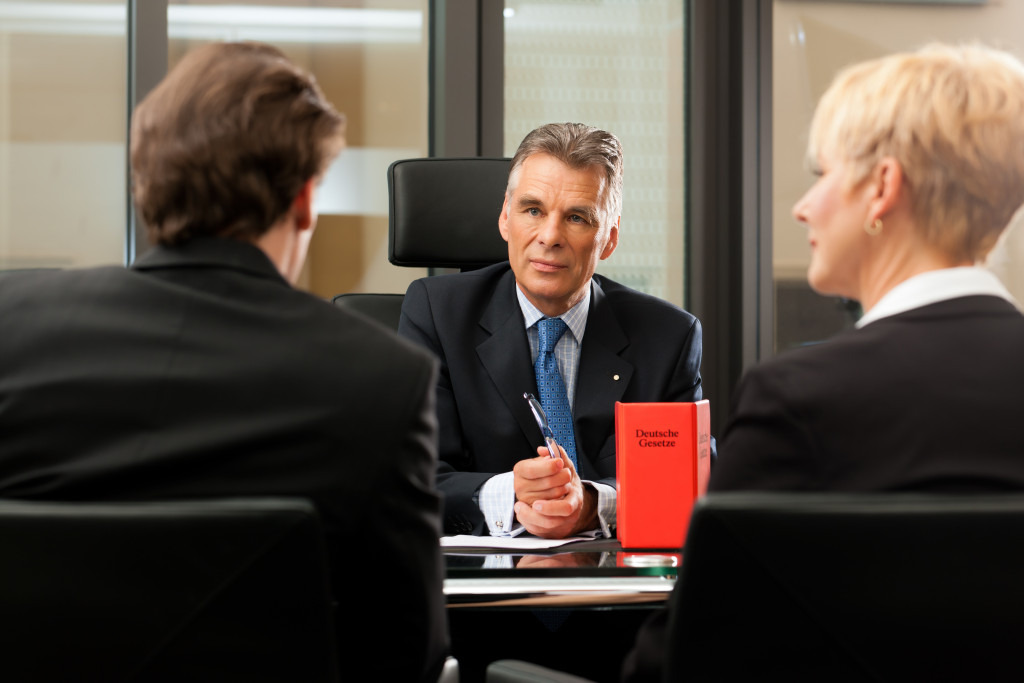 a lawyer with his clients in office