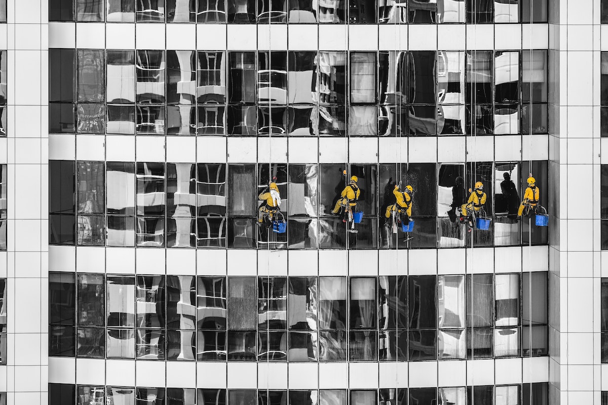 workers cleaning the exterior of a building
