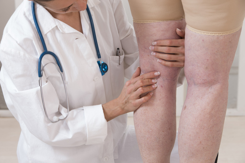 a woman doctor examining the leg