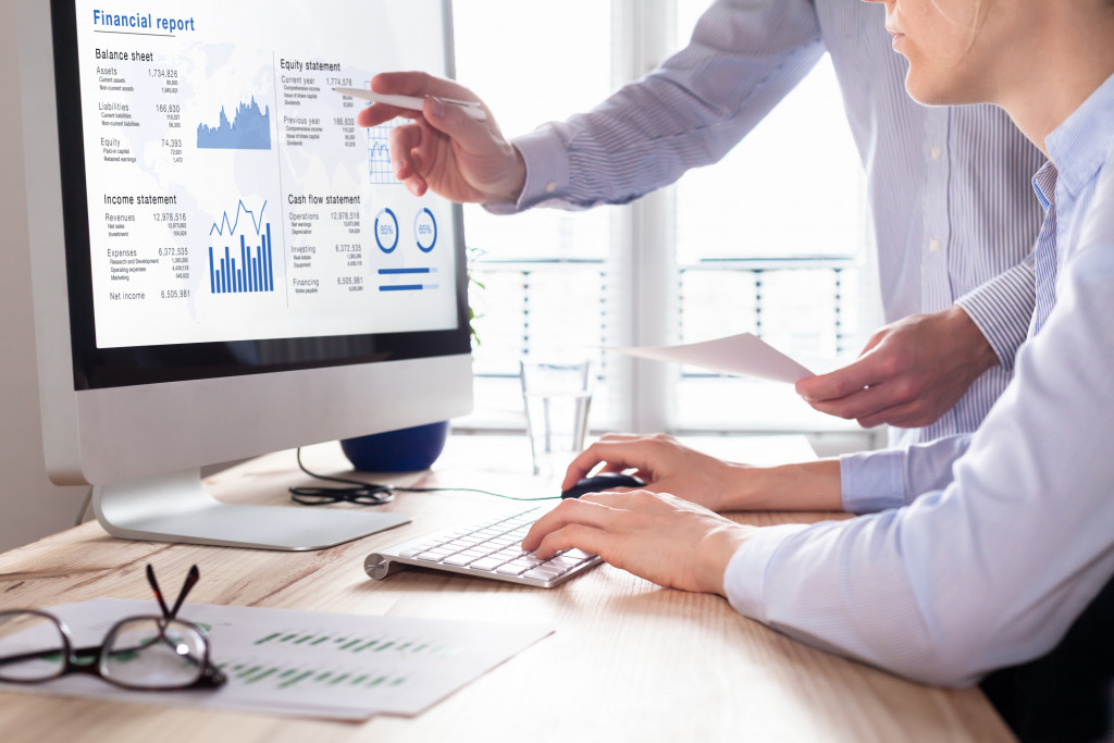 woman being instructed to research financial reports by male boss