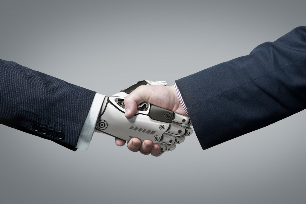 Shaking hands robot and man