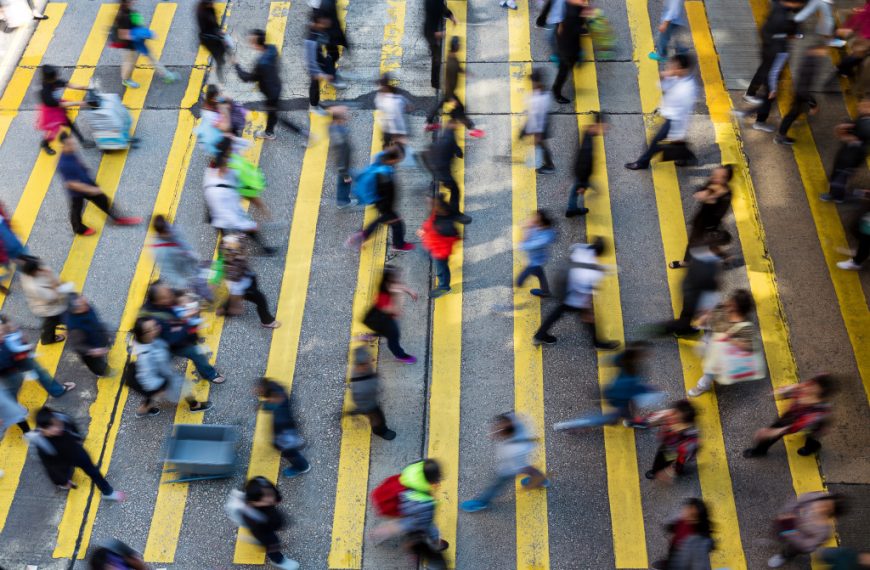 People moving around and crossing the street