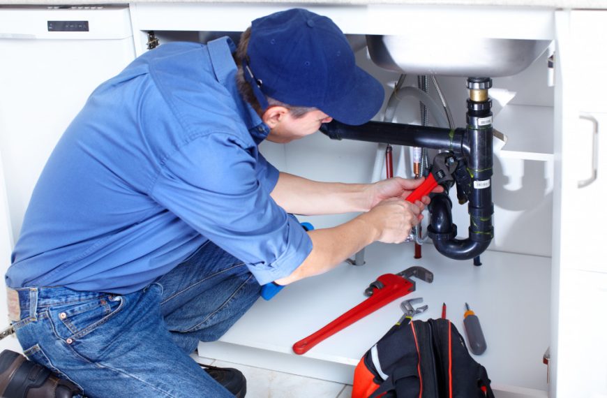 A professional plumber fixing a sink