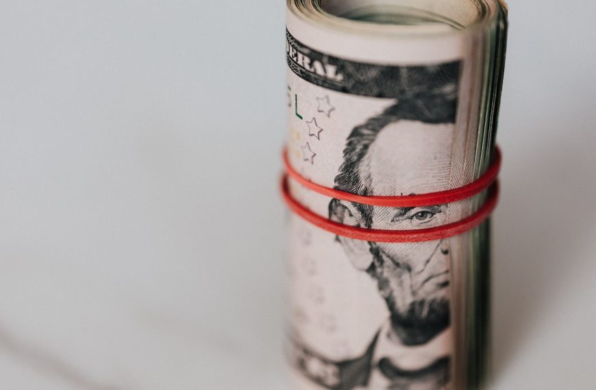 Roll of american dollars tightened with red band