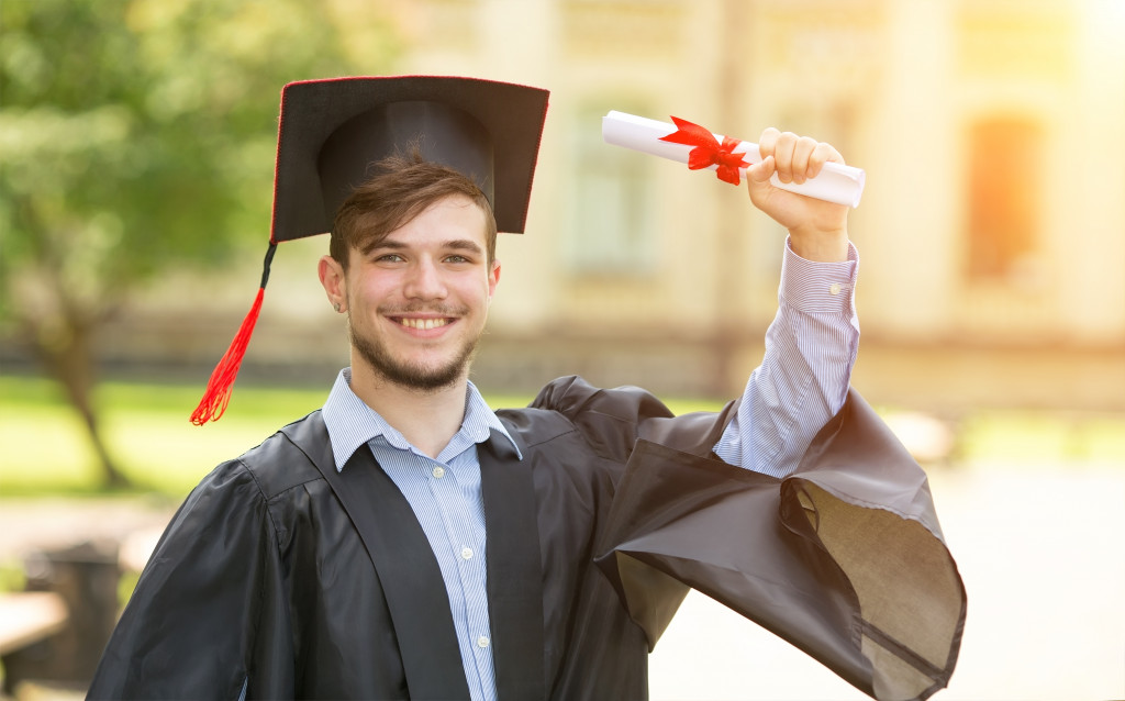 A man graduating with a college degree