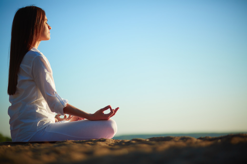 Meditating woman outdoors