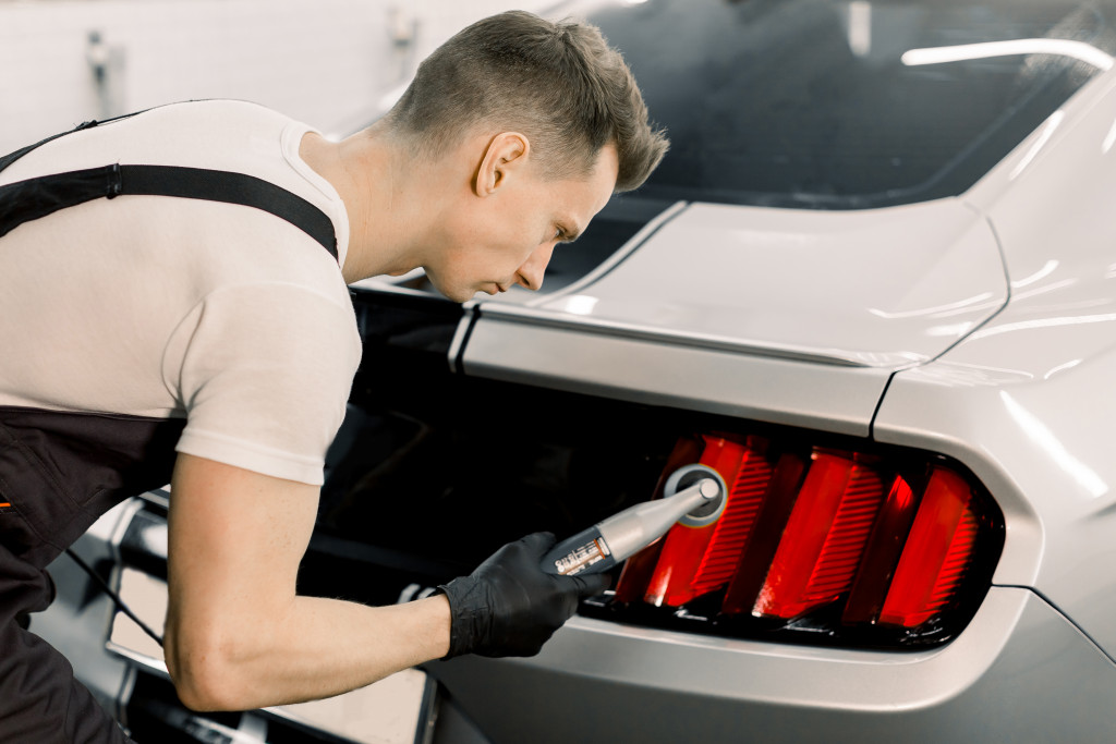 man working on a car's details