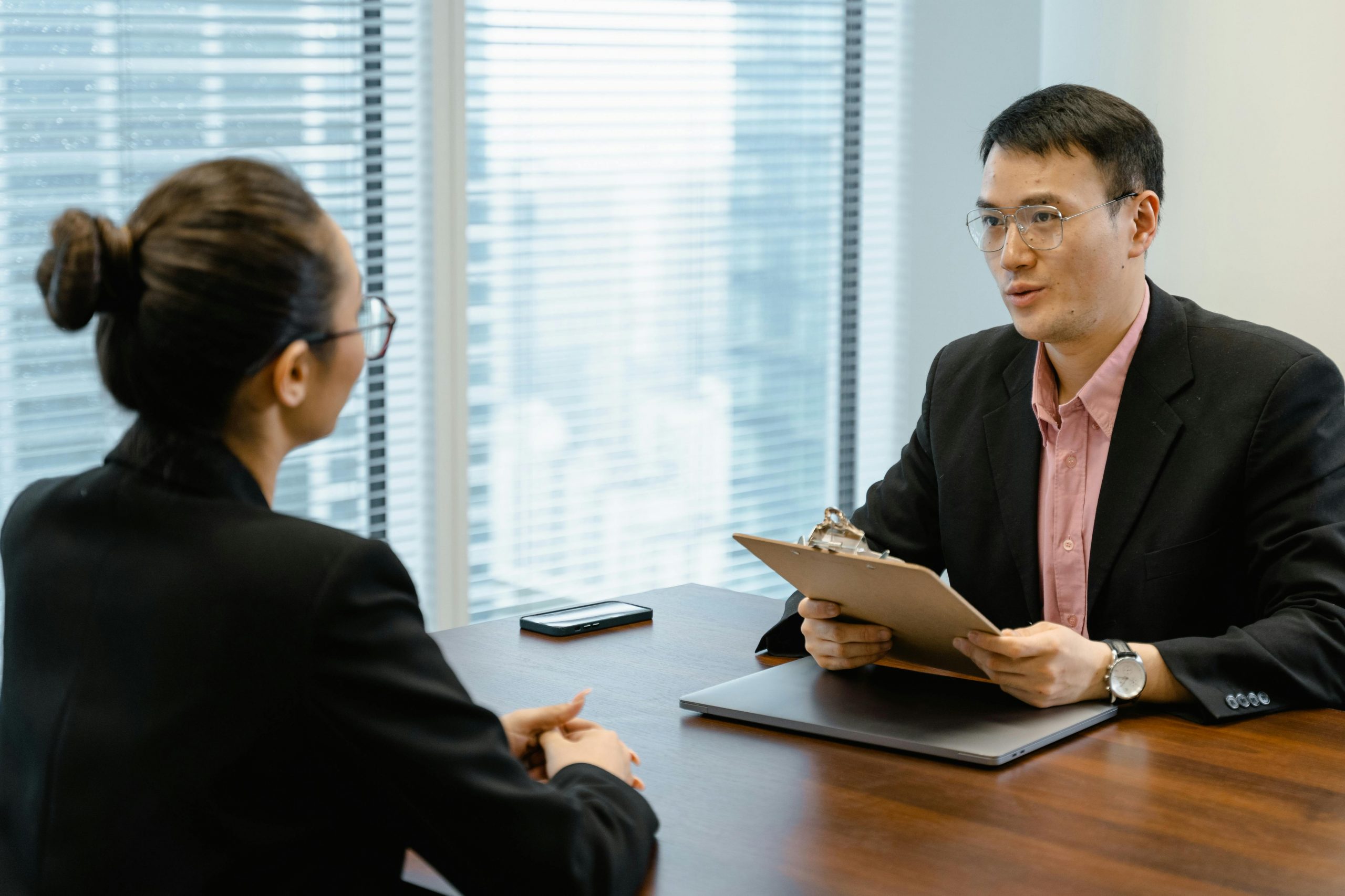 interviewer and job applicant seated at a desk
