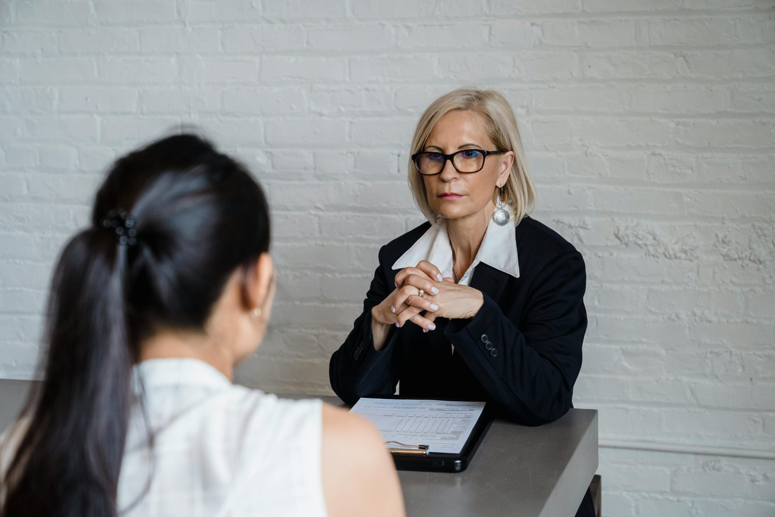 interviewer with a serious expression looking at a candidate